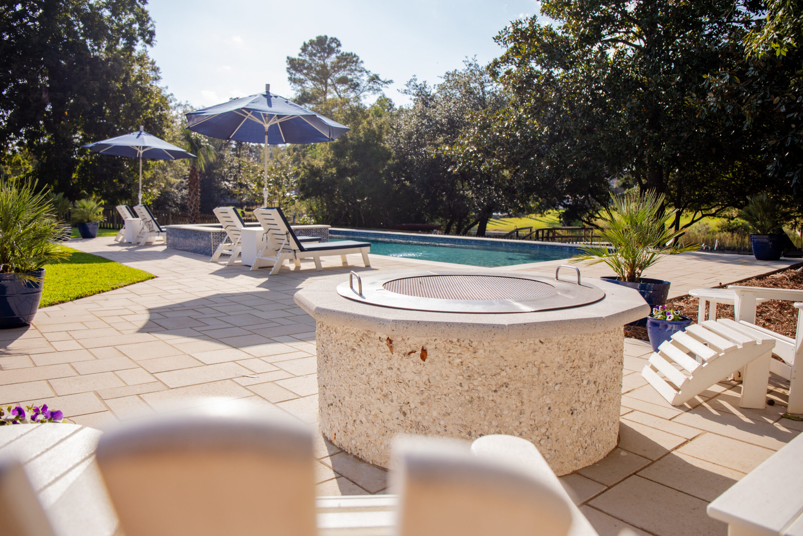Poolside with lounge chairs and umbrellas