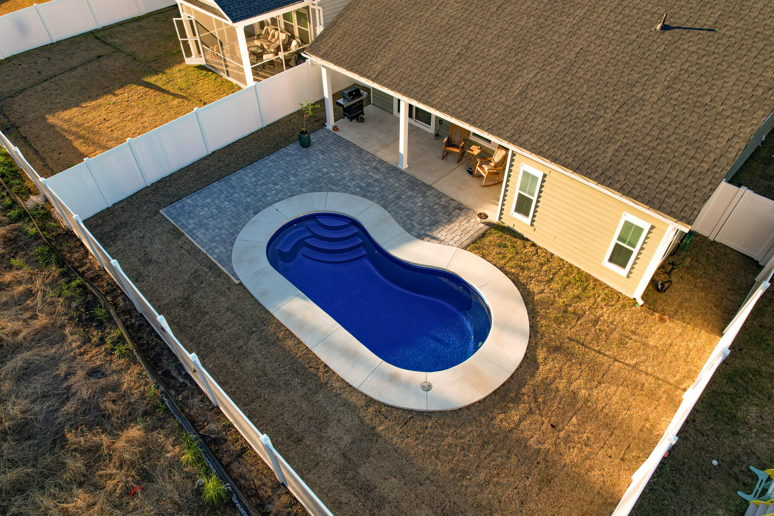 Backyard with a pool and patio.