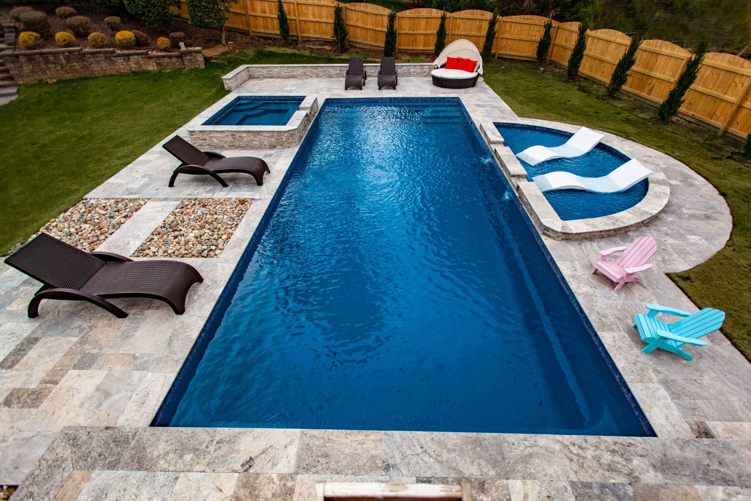 Modern pool with lounge chairs and spa