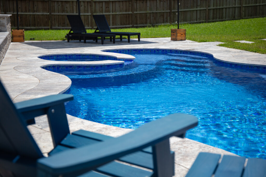 Blue pool with lounge chairs nearby