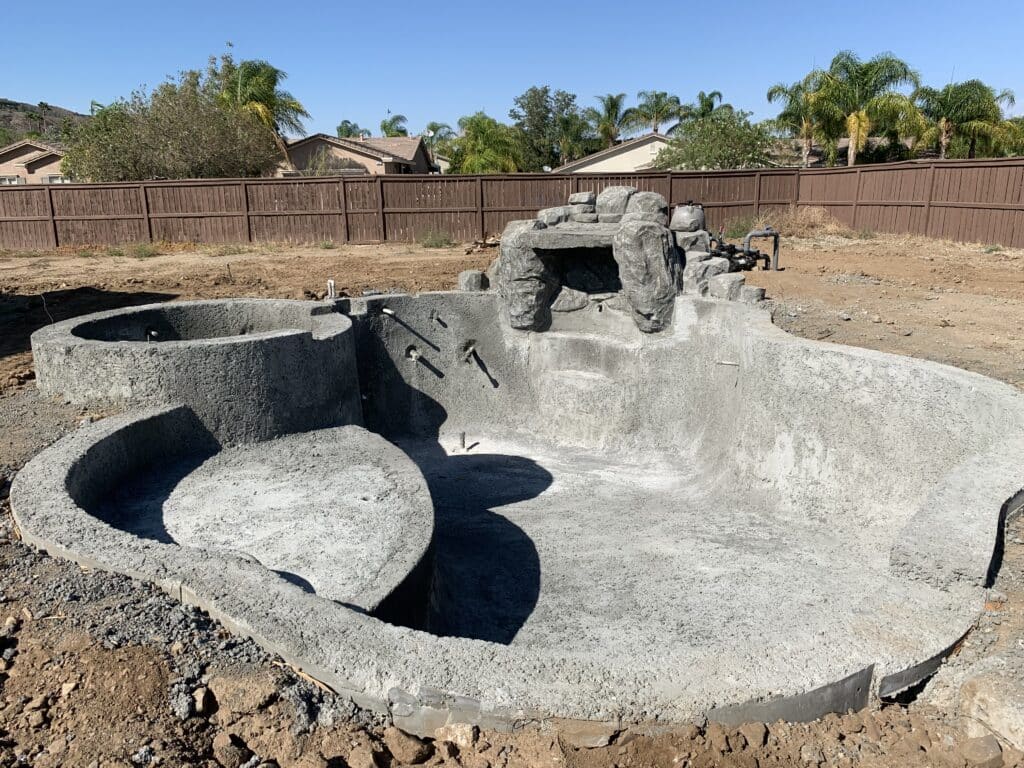 Empty concrete pool under construction.
