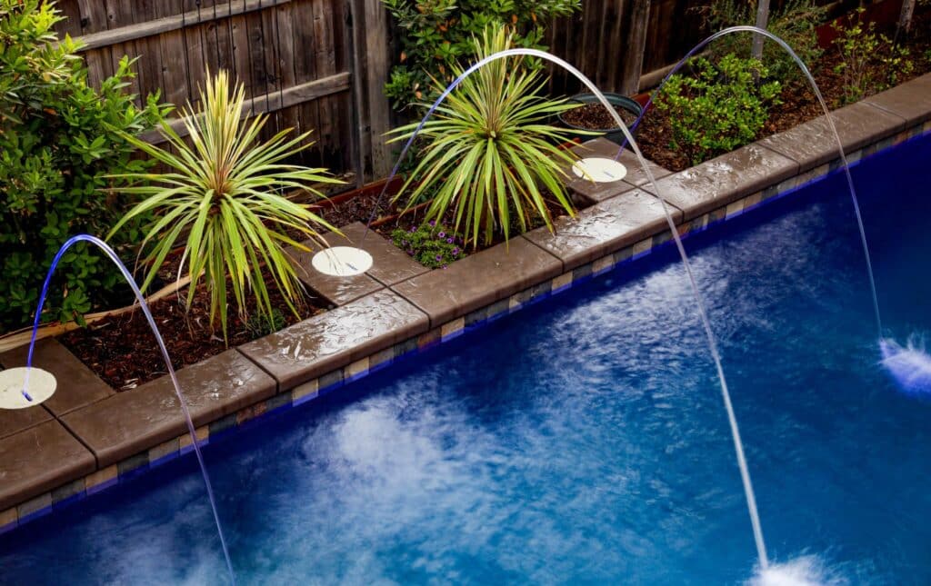 Swimming pool with water features and plants