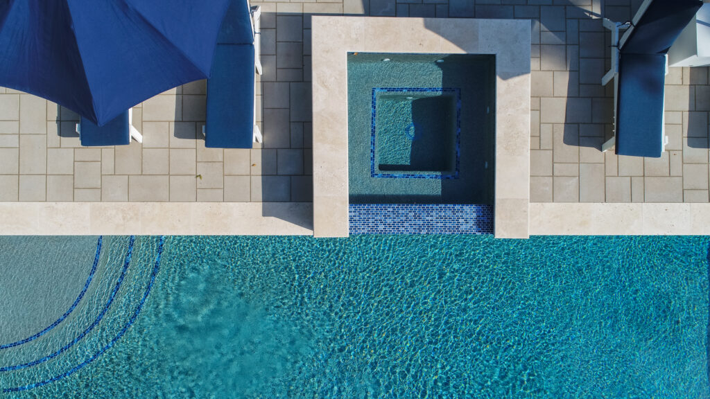 Aerial view of concrete pool and spa