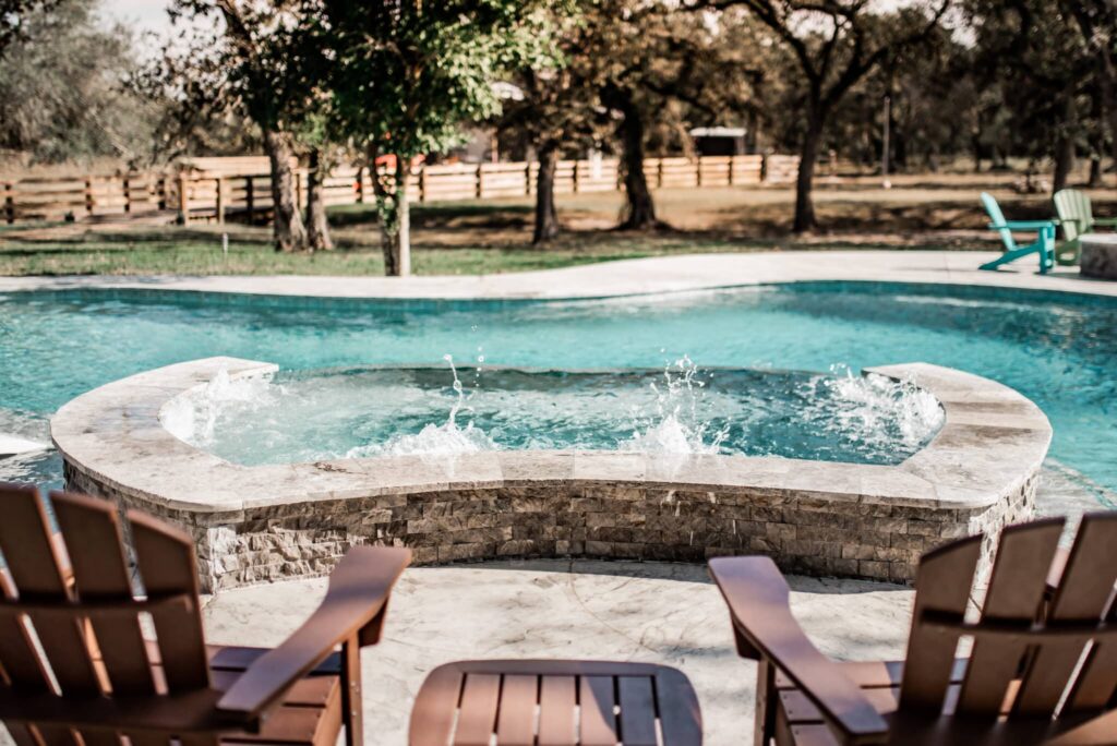 Pool with spa and wooden chairs