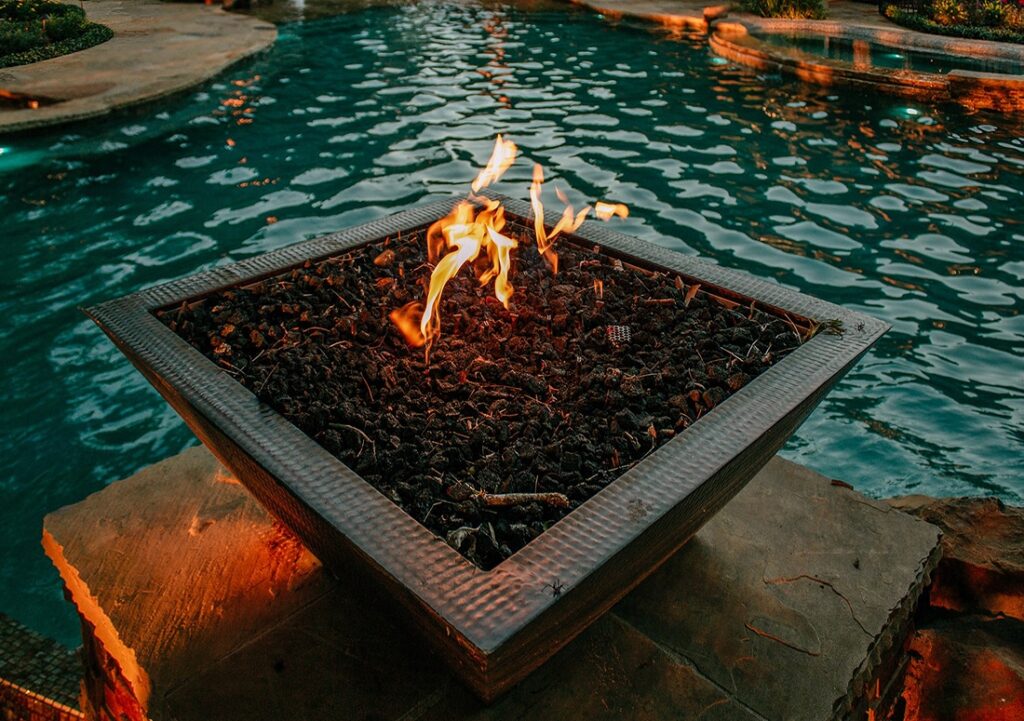 Fire pit beside a swimming pool