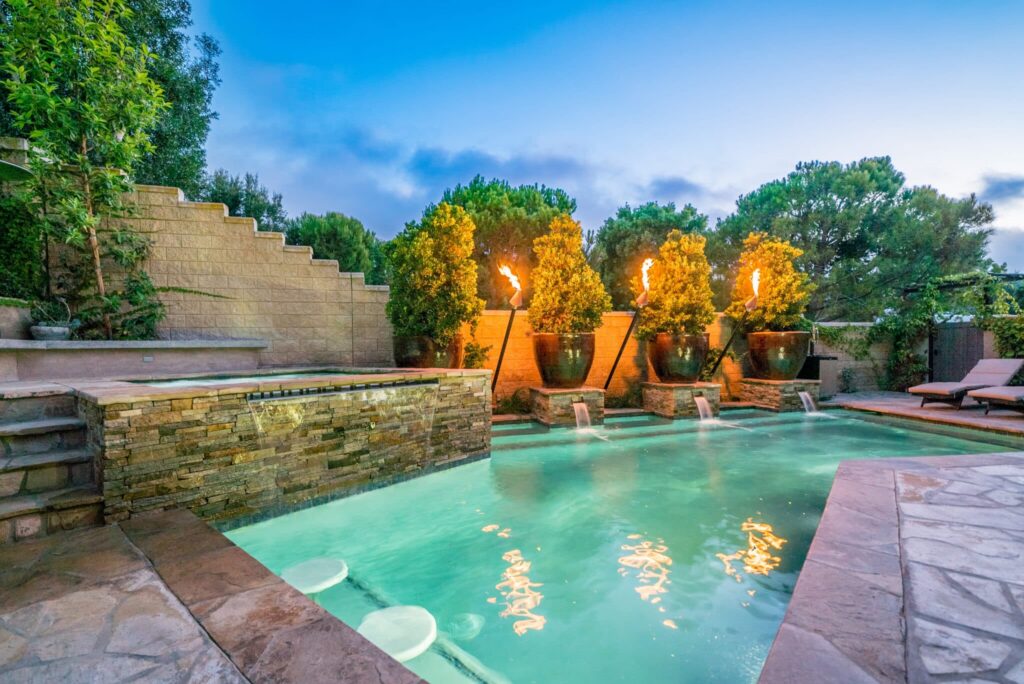 Elegant pool with fire features.