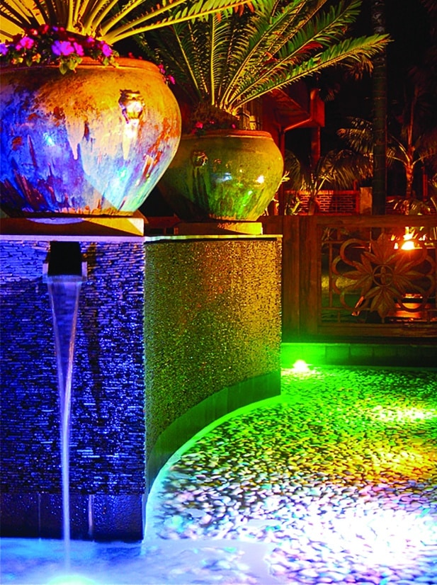 Colorful illuminated water feature at night