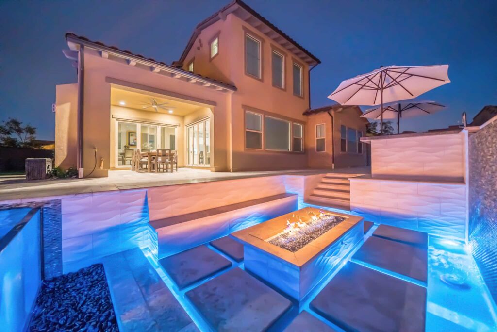 Modern home with illuminated pool area