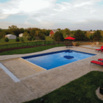 Elegant pool with lounge chairs and umbrella