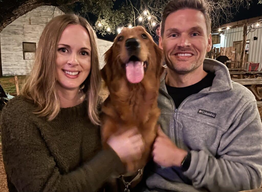 Couple with a golden retriever dog