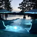 Illuminated pool by serene lake