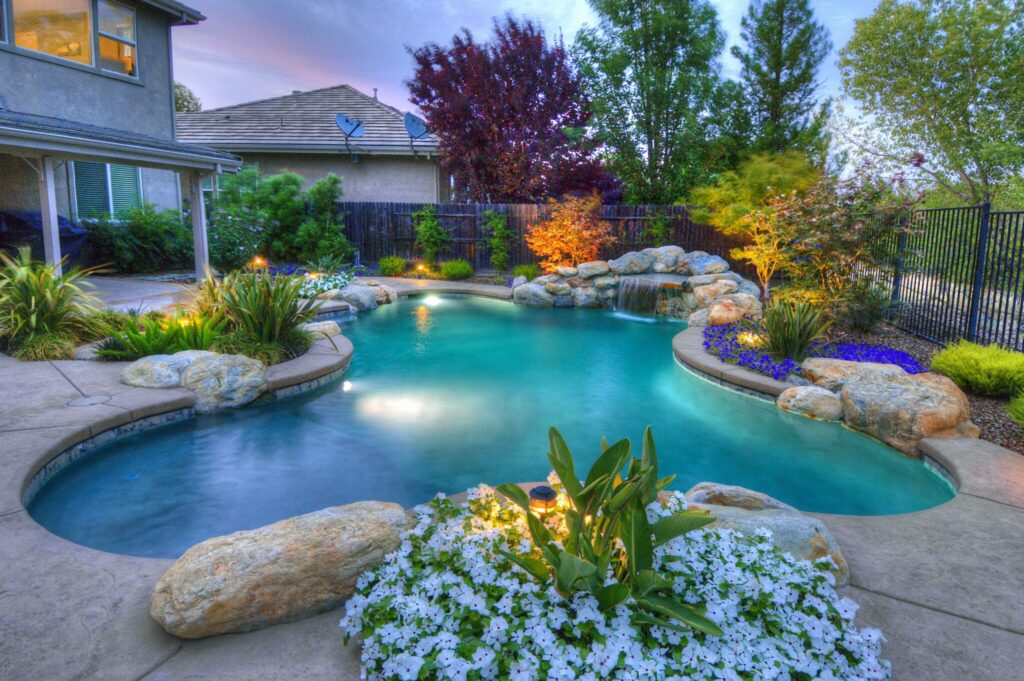 Serene backyard pool with landscaping.