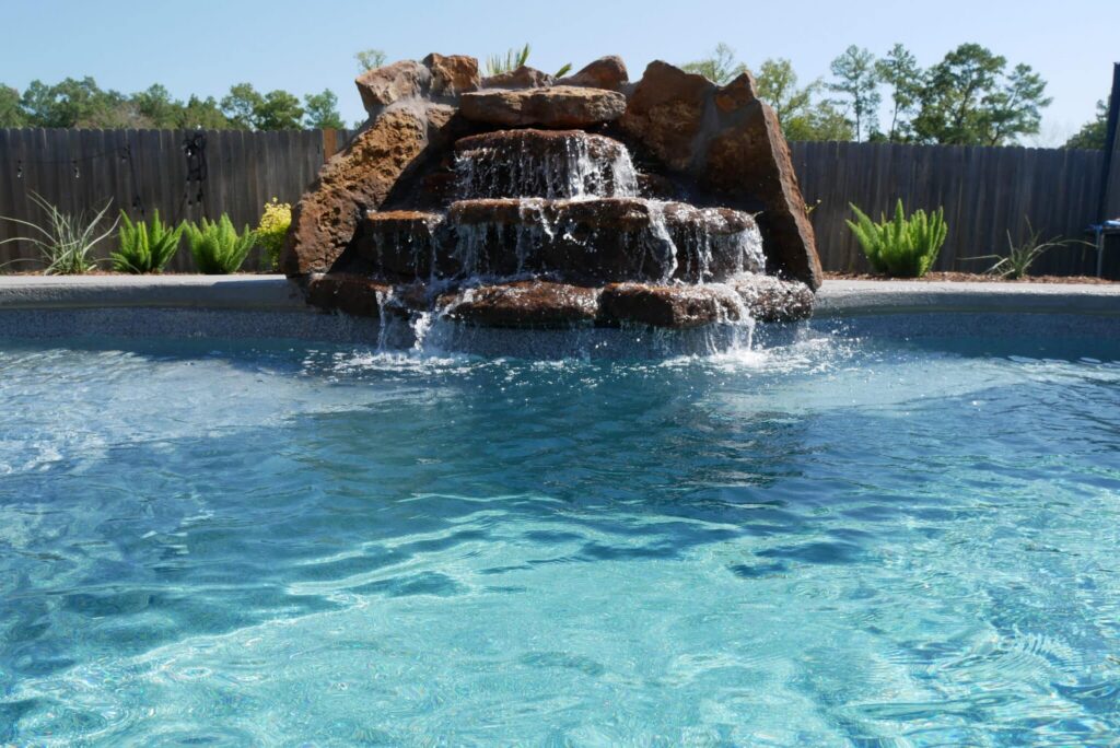 Waterfall feature in a swimming pool