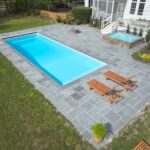 Swimming pool with patio and loungers