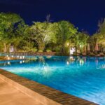 Serene pool surrounded by lush greenery