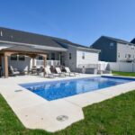 Backyard pool with lounge chairs