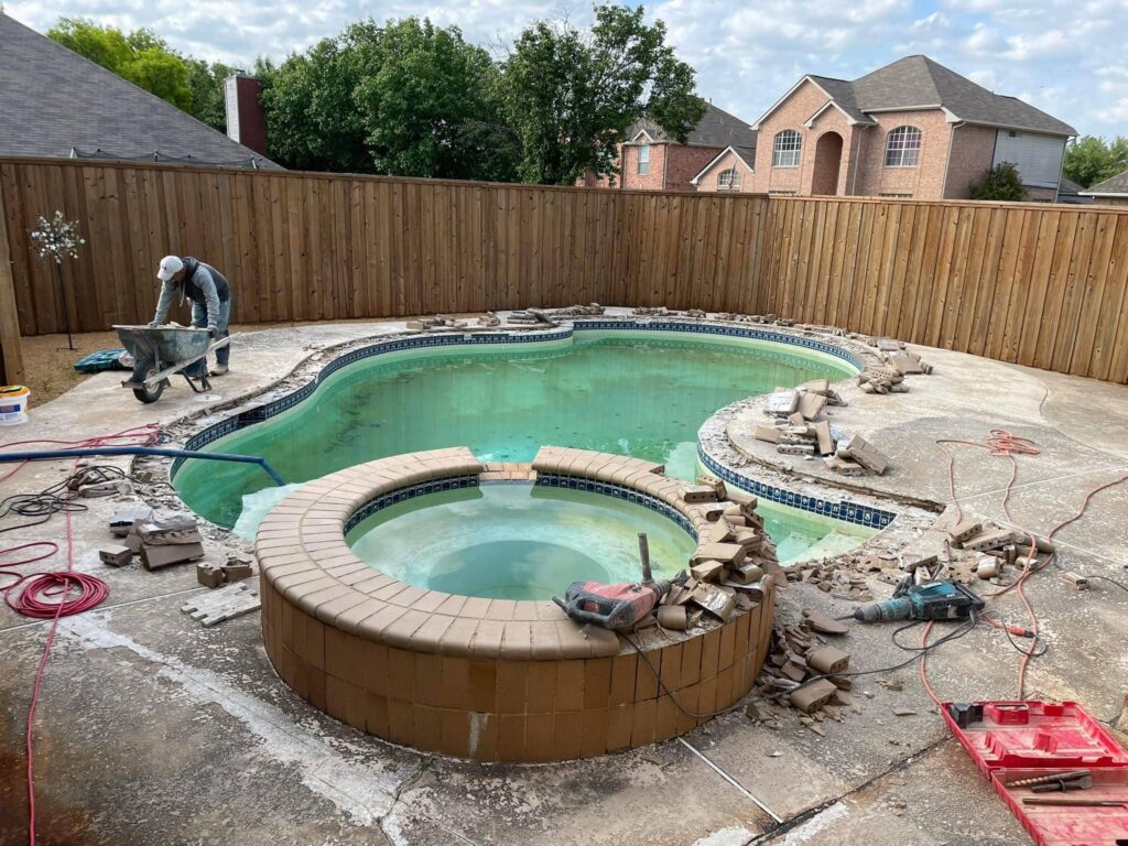 Pool renovation in progress with worker