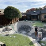 In-ground pool remodel construction in backyard.