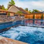 Luxury fiberglass pool with waterfall features and spa