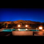 Pool with flames and mountain backdrop