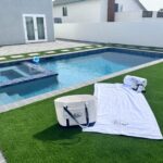 Poolside with towels and grass