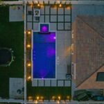 Aerial view of illuminated backyard pool