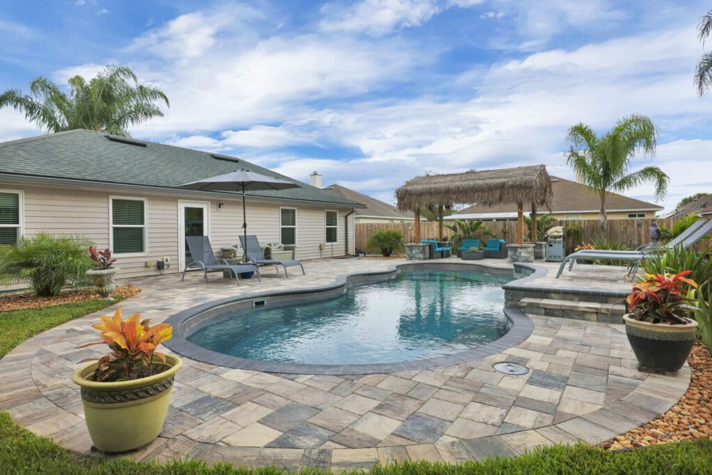 "Fiberglass Pool in a backyard with Palm Trees"